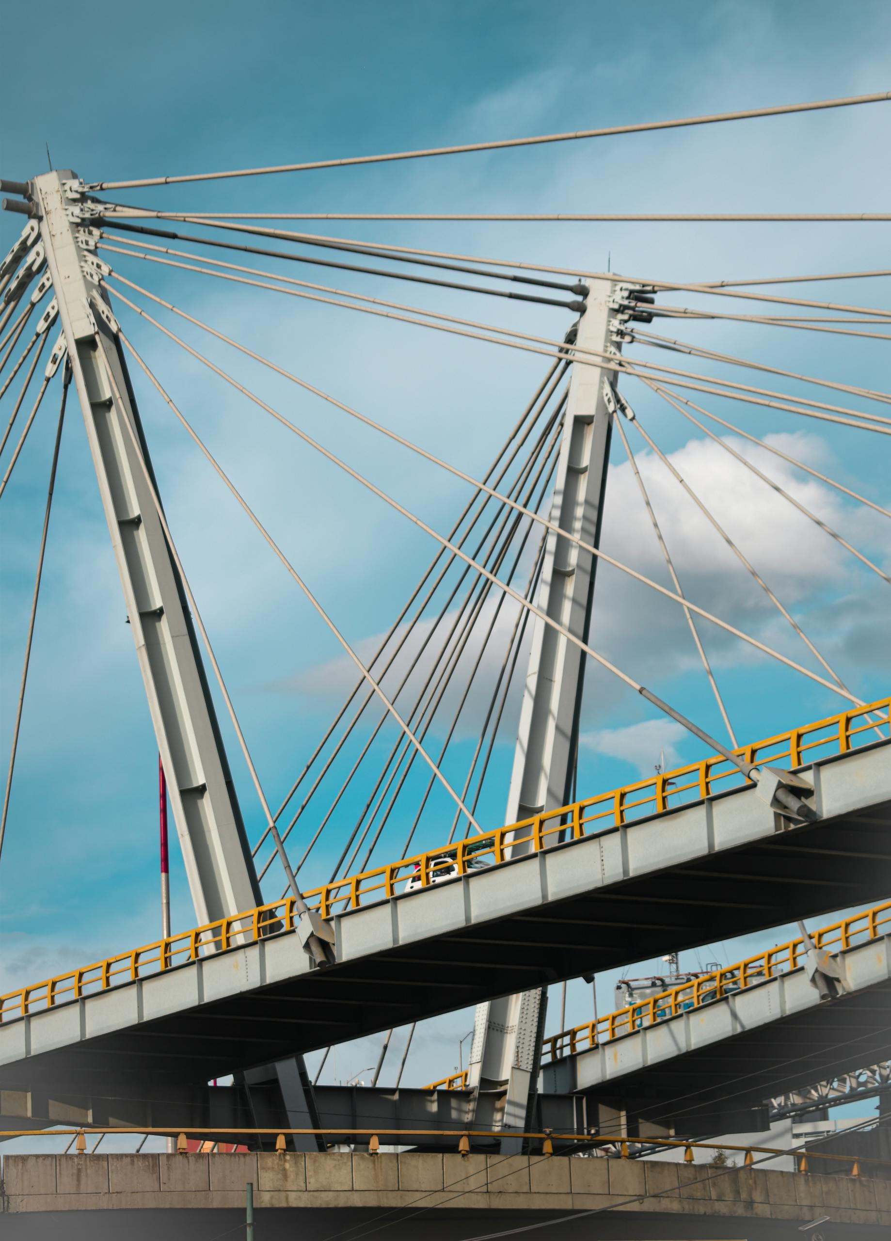 A striking view of a modern suspension bridge against a blue sky in Mexico City.